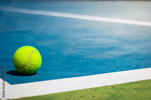 Tennis balls in court on corner blue floor © MoJoeMoJo