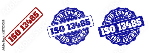 ISO 13485 grunge stamp seals in red and blue colors. Vector ISO 13485 labels with scratced surface. Graphic elements are rounded rectangles, rosettes, circles and text labels.