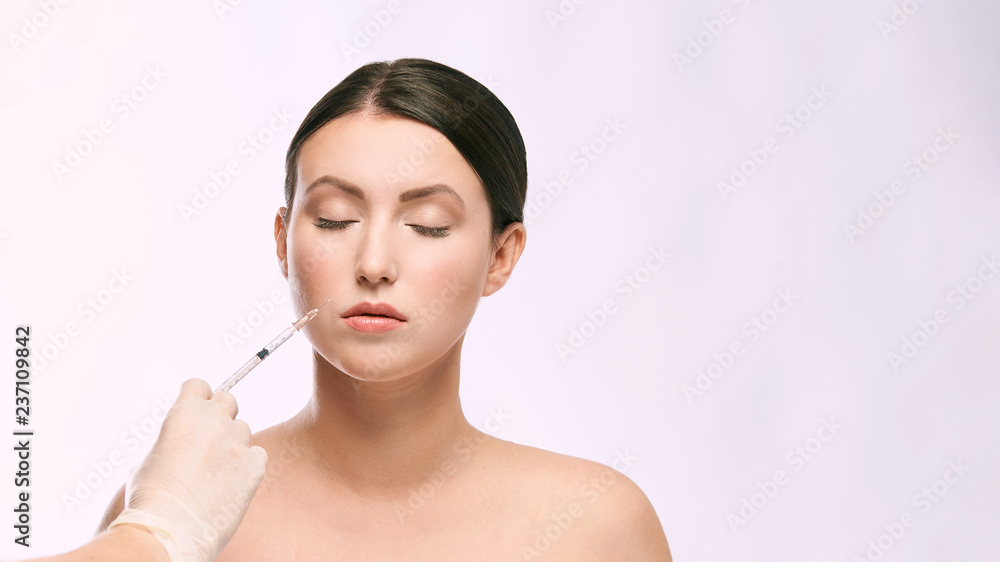 Face needle injection. Young woman cosmetology procedure. Doctor gloves Face needle injection. Young woman cosmetology procedure. Doctor gloves