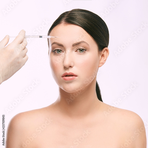 Face needle injection. Young woman cosmetology procedure. Doctor gloves