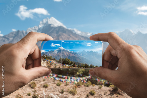 Taking picture using the mobile phone. Himalayan mountains: Kangtega, Tamserku, Kusum Kanguru, Kyashar photo