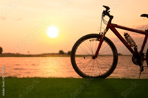 Silhouette bicycle with sunset or sunrise background