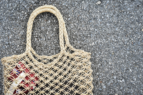 handmade women bag from water hyacinth on road texture in the background