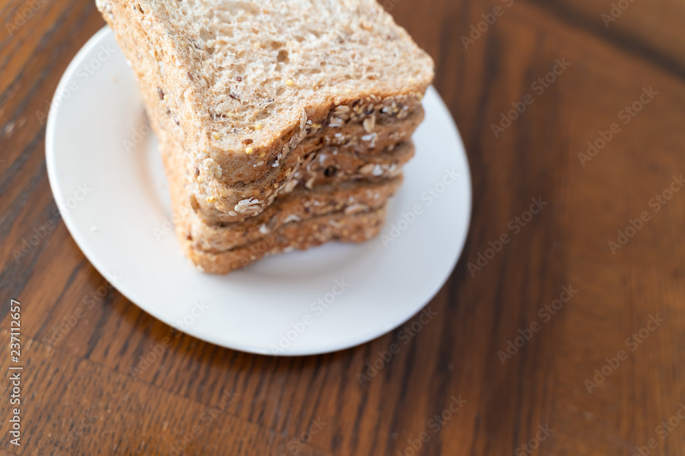 Slices of Whole grain bread on white plate Slices of Whole grain bread on white plate