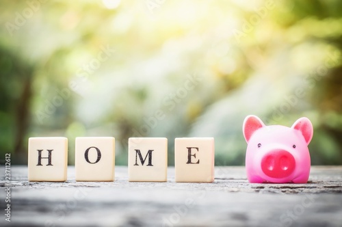 Business concept, saving coins with pink piggy bank for home photo