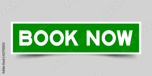 Square green color sticker with word book now on gray background