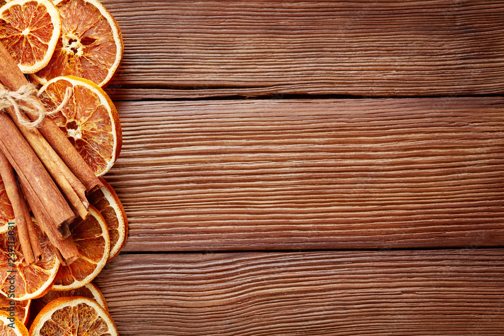 dry orange slices, cinnamon sticks and anise on wooden background dry orange slices, cinnamon sticks and anise on wooden background