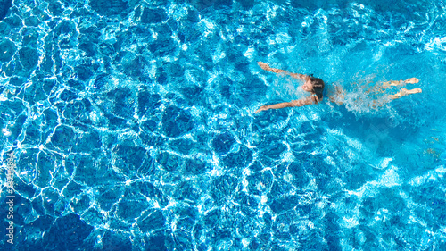 Active girl in swimming pool aerial drone view from above, young woman swims in blue water, tropical vacation, holiday on resort concept   © Iuliia Sokolovska