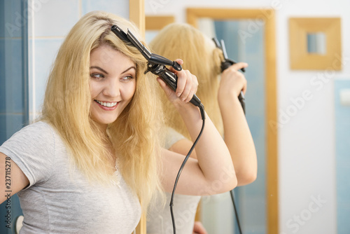 Woman using hair curler