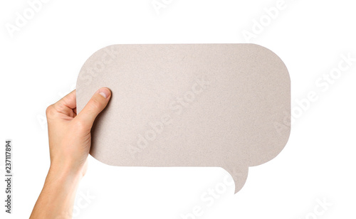 Hand holding an empty speech bubble. Close up. Isolated on white background