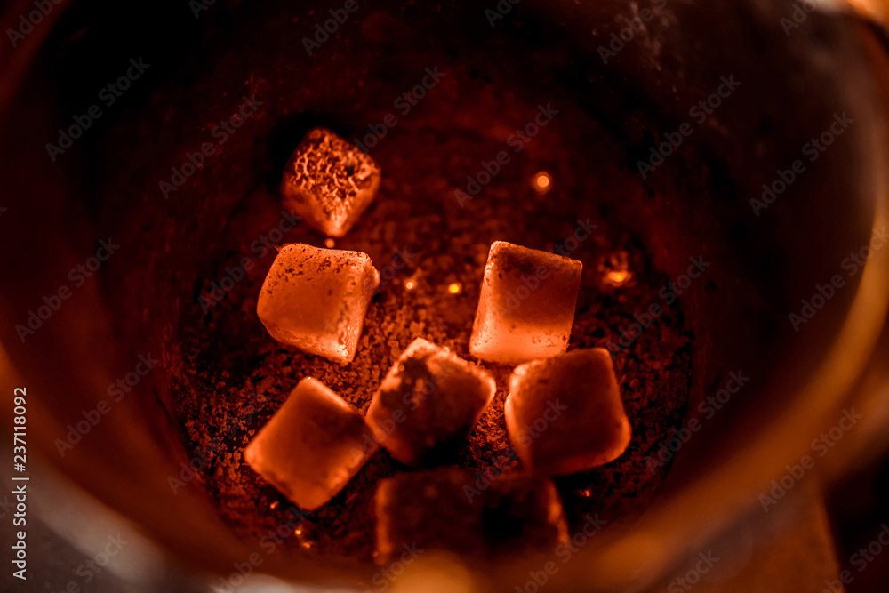 hot red coals with hookah sparks in metal bowl for Shisha Smoking and traditional Asian relaxation close up hot red coals with hookah sparks in metal bowl for Shisha Smoking and traditional Asian relaxation close up