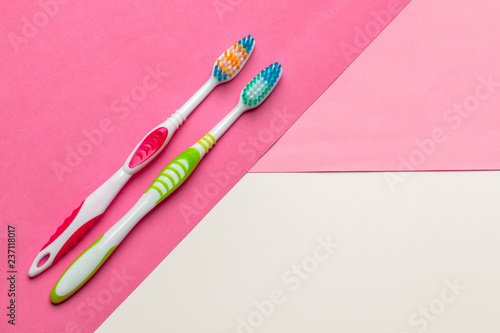 Toothbrushes on pink background