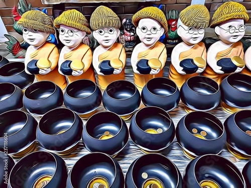 Fotografija Cartoon illustration of cute little buddhist monks figurines with wool bonnet an