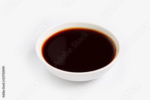 Soy sauce in glass bowl isolated on white background