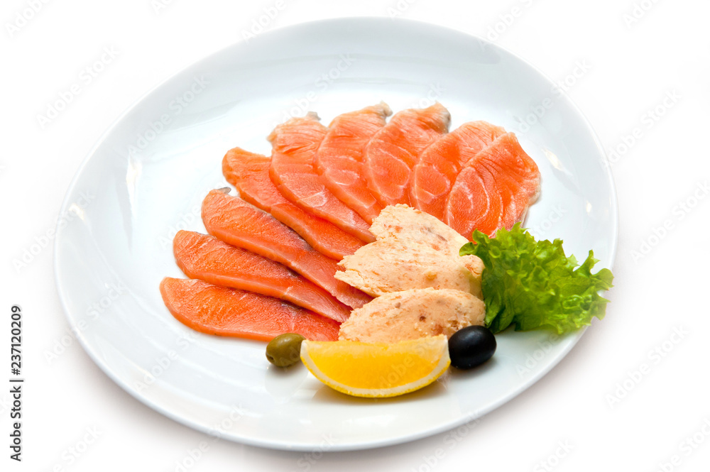 Cutting red fish with an orange slice in greens and olives Cutting red fish with an orange slice in greens and olives
