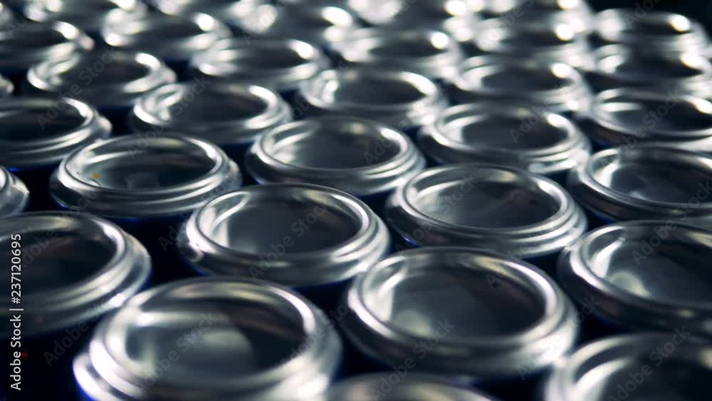 Lots of metal aluminum cans on a conveyor. Lots of metal aluminum cans on a conveyor.