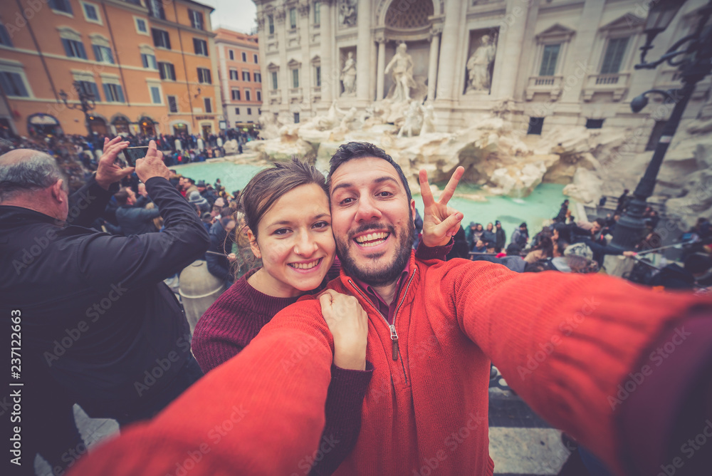 tourism in Rome, handsome couple smiling in the Trevi Fountain in Rome, Italy