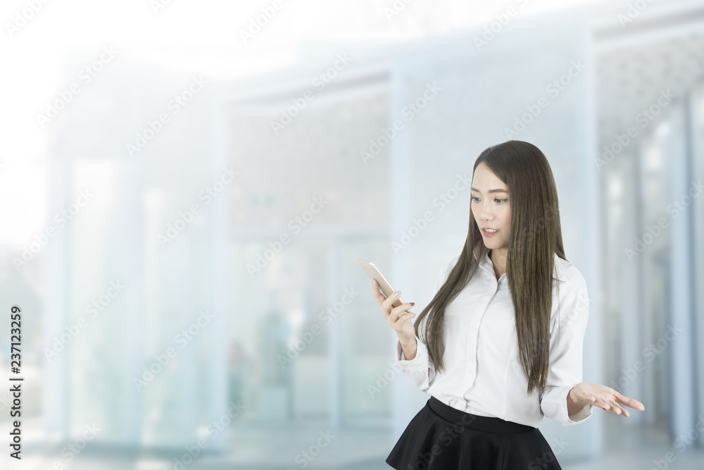 Confused asian businesswoman using smartphone.