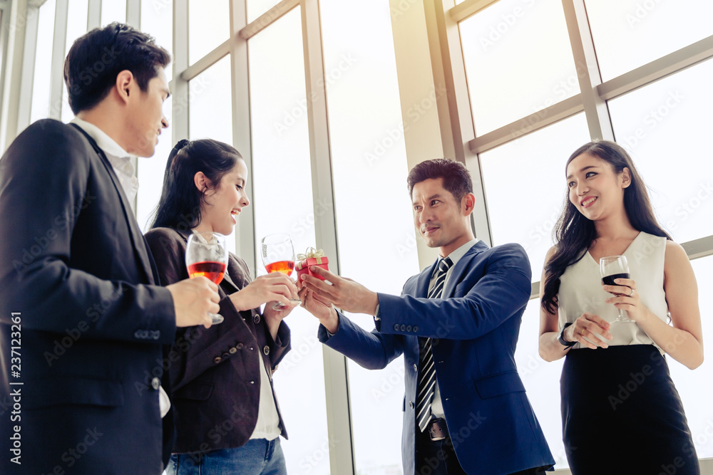 Party concept business men holding gift box give to businesswomen Party concept business men holding gift box give to businesswomen