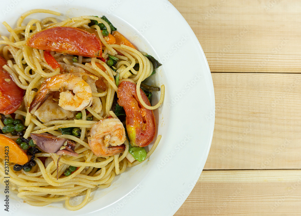 Spaghetti seafood in a dish on a white wood floor table, Top view with copy space for your text... Spaghetti seafood in a dish on a white wood floor table, Top view with copy space for your text...