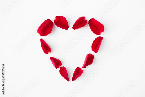 valentines day and romantic concept - heart shape made of red rose petals on white background