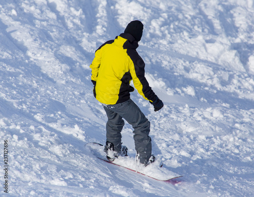 A man snowboarding a mountain in the snow in winter