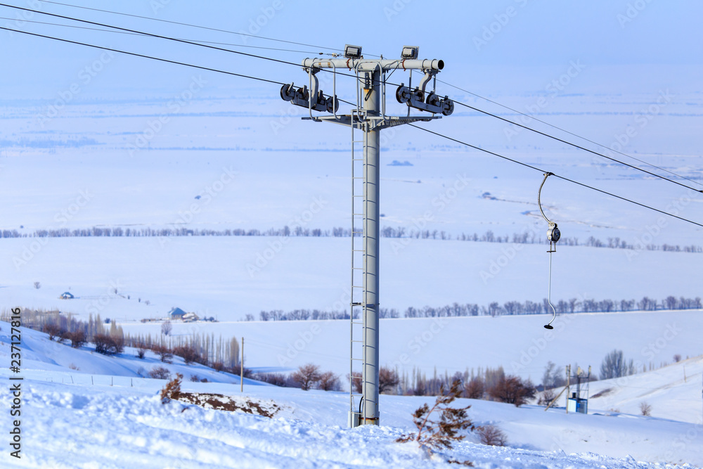 Ski lift and snowboarders in the mountains Ski lift and snowboarders in the mountains