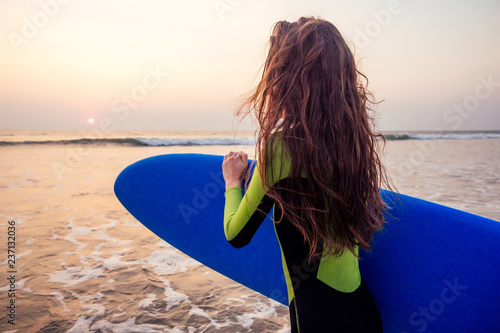 Canvas Print active women with surf board enjoy watersport at vacation holidays