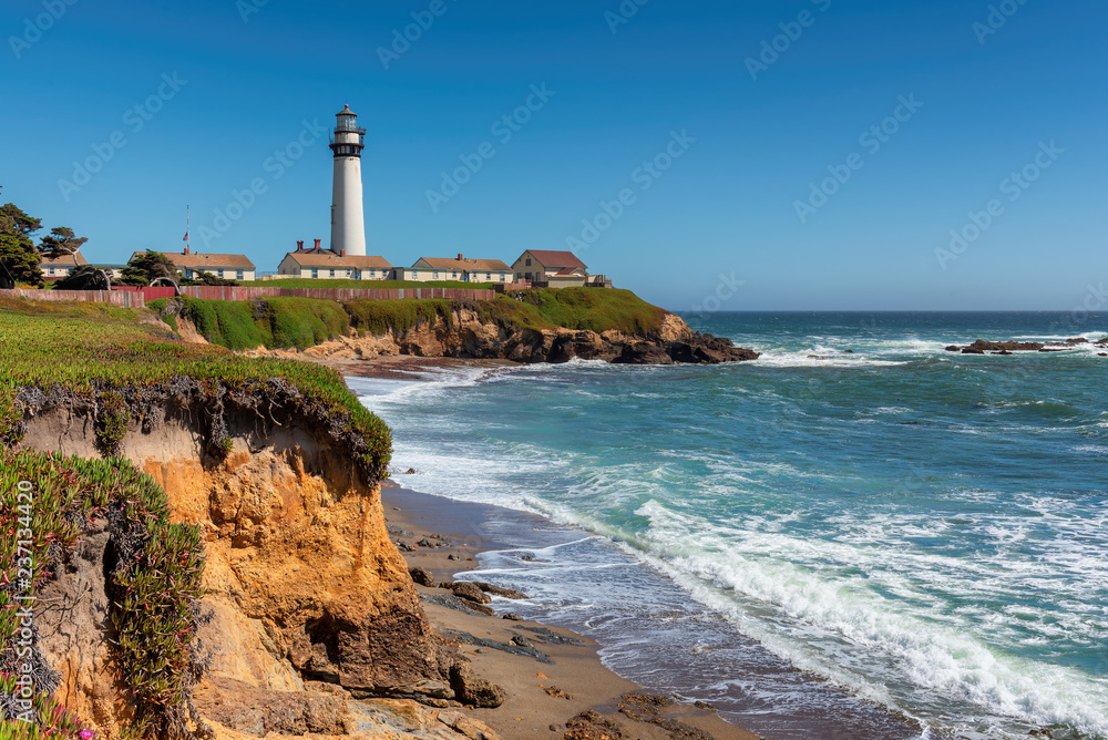 California beach with lighthouse. Pigeon Point Lighthouse in a sunny day. Pacific Ocean coastline, Pescadero, California