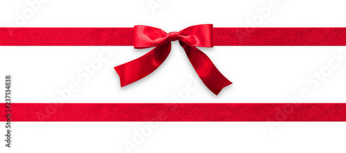 Red ribbon band stripe or satin fabric bow isolated on white background with clipping path for banner design, greeting card and Christmas gift decoration