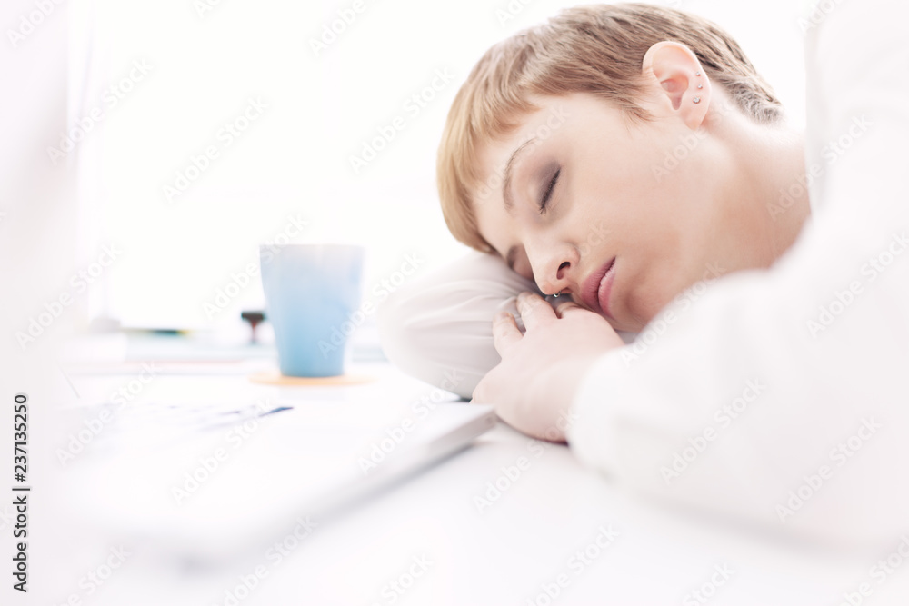 Tired businesswoman sleeping on her desk Tired businesswoman sleeping on her desk