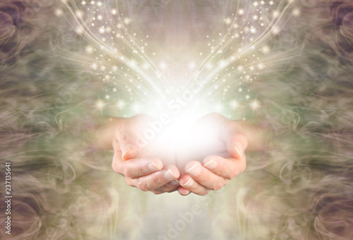 Sending You High Resonance Healing Energy - female cupped hands emerging from a green gold swirling energy field background with shimmering sparkles and white light flowing outwards
