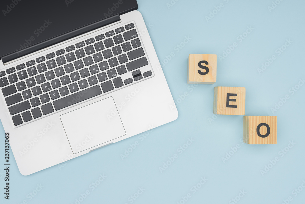 Top view of digital device near wooden cubes on light blue background Top view of digital device near wooden cubes on light blue background