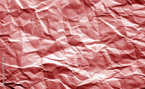 Crumpled sheet of paper in red color. photo