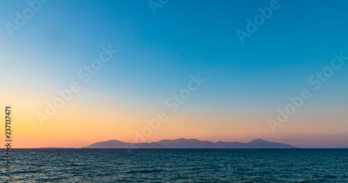 Fototapeta Naklejka Na Ścianę i Meble -  Greek Island Silhouette At Sunset