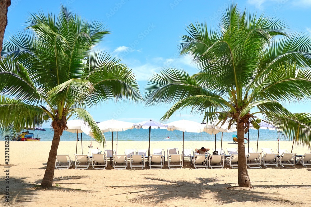 Bed beach and umbrella on tropical beach with coconut tree in the summer morning. Nature and travel concept. Bed beach and umbrella on tropical beach with coconut tree in the summer morning. Nature and travel concept.