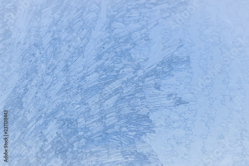 Painted developed frosty patterns on the winter ice window