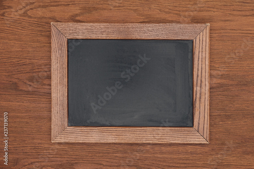 top view of empty chalk board on wooden background
