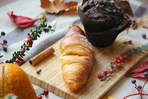 Chocolate Muffin and Croissant on Witner Themed Background