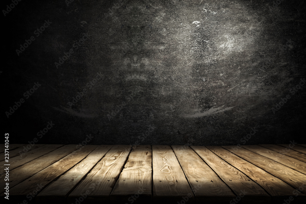 Dark wooden table with shadow and black wall background Dark wooden table with shadow and black wall background