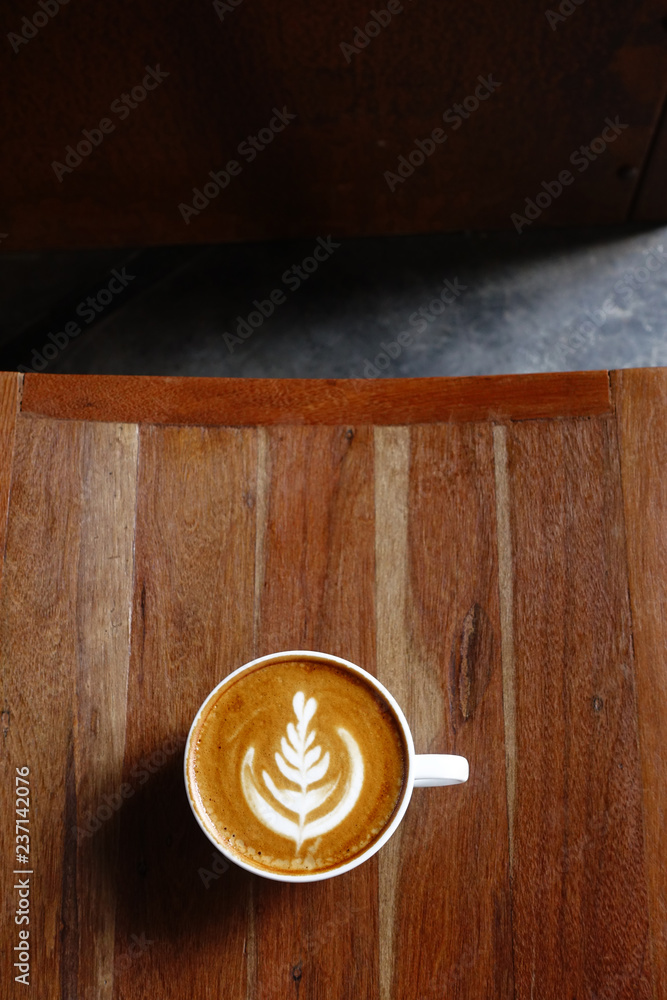 a cup of latte art coffee on wooden background a cup of latte art coffee on wooden background