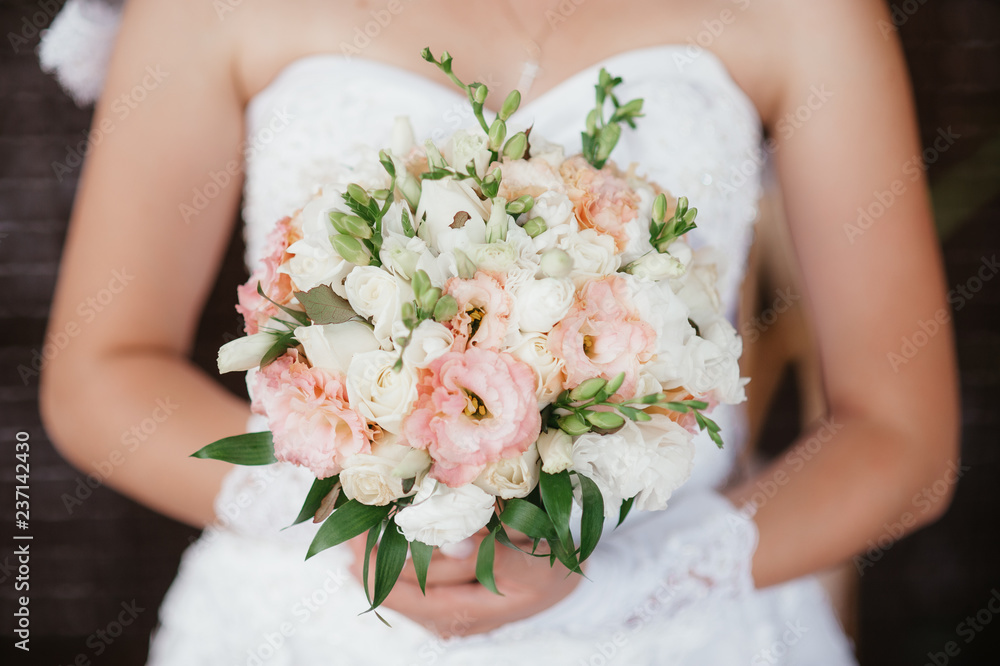 bride holding a bouquet of flowers in a rustic style, wedding bouquet. Soft focus bride holding a bouquet of flowers in a rustic style, wedding bouquet. Soft focus