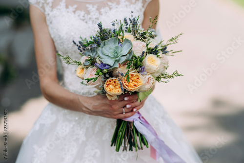 bride holding a bouquet of flowers in a rustic style, wedding bouquet. Soft focus