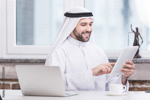 Arabian businessman using digital tablet in office photo