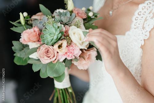 bride holding a bouquet of flowers in a rustic style, wedding bouquet. Soft focus