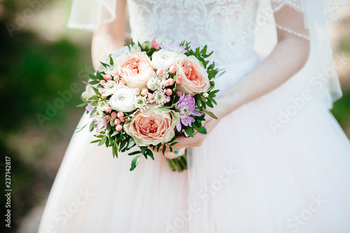 bride holding a bouquet of flowers in a rustic style, wedding bouquet. Soft focus