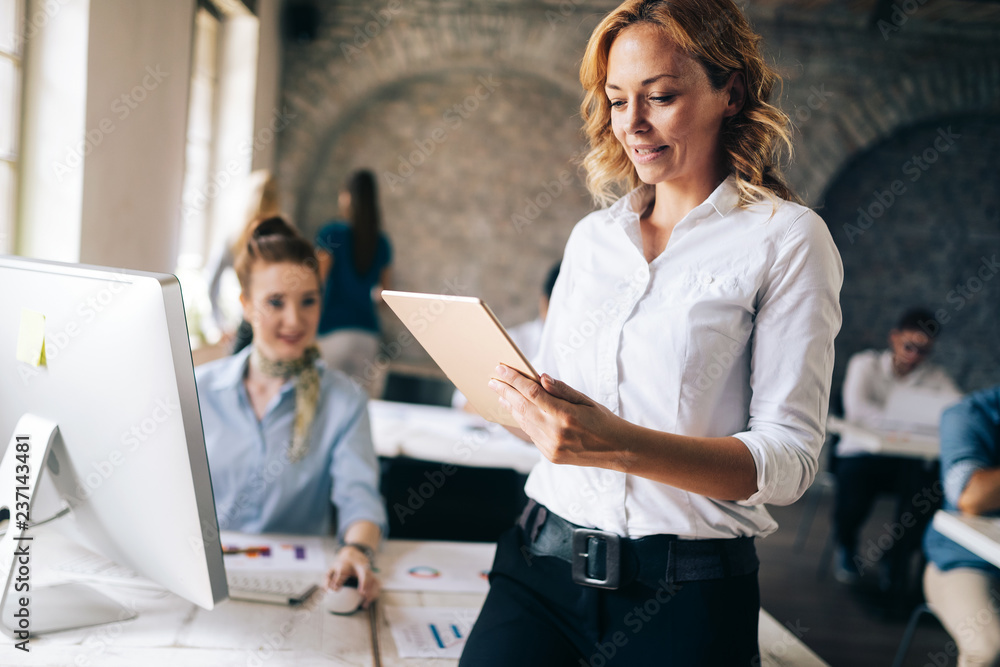 Business, technology and people concept - creative team or designers working in office Business, technology and people concept - creative team or designers working in office