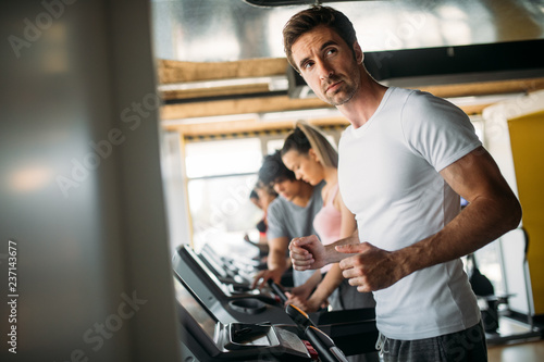 Group of young people running on treadmill in gym