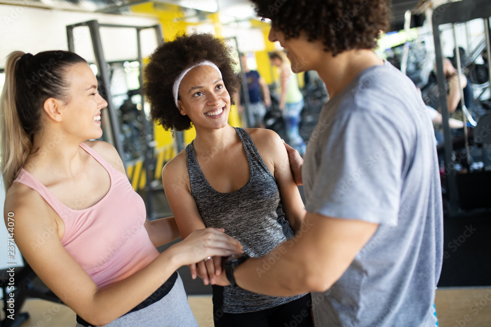 Group of young people doing exercises in gym Group of young people doing exercises in gym