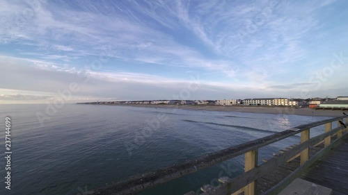 view of the ocean looking over the railing of the fishing pier 